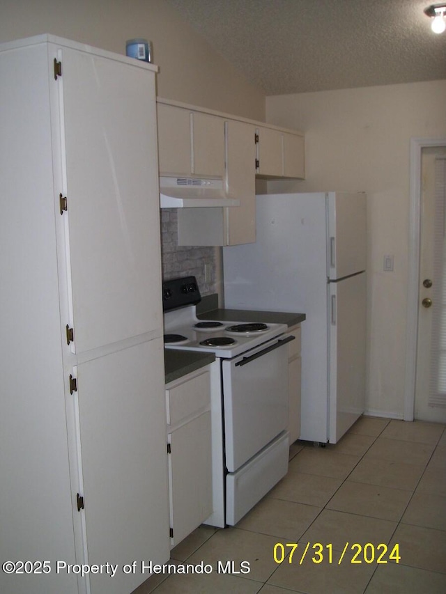 kitchen with tasteful backsplash, white cabinets, a textured ceiling, white appliances, and under cabinet range hood