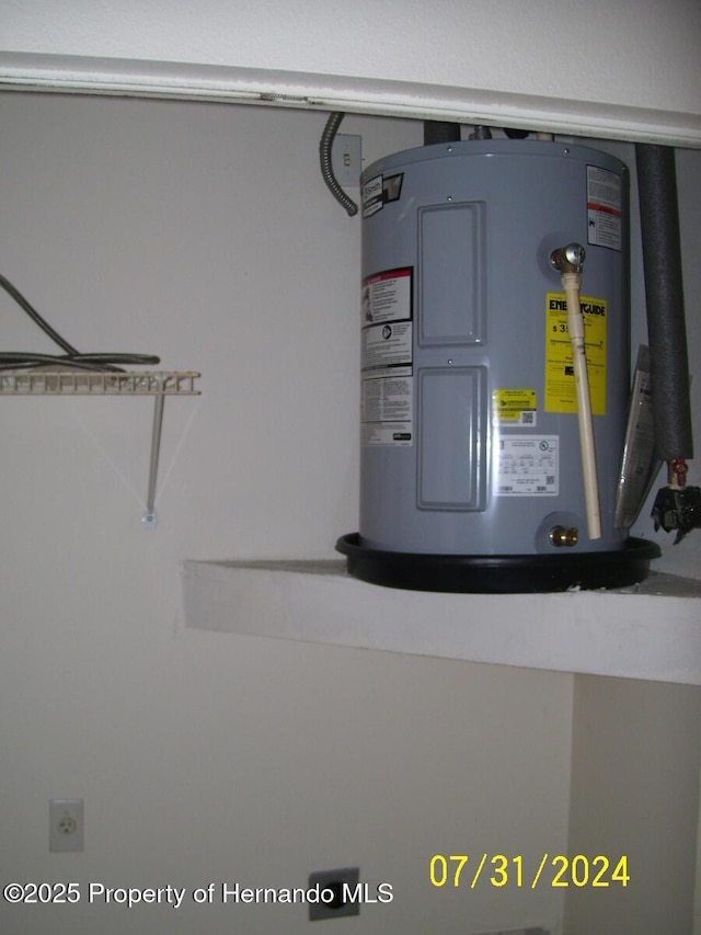 utility room featuring water heater