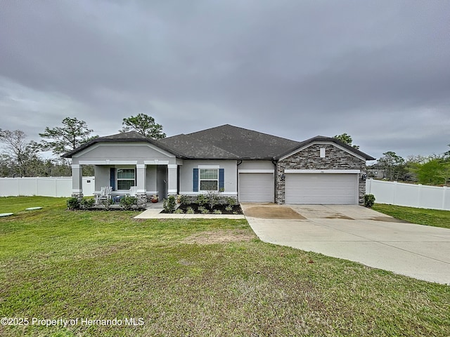 view of front facade featuring a garage, fence, driveway, and a front lawn