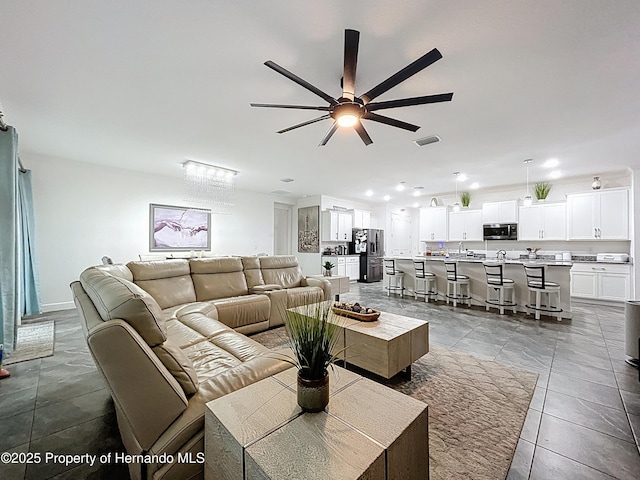 living area with a ceiling fan, tile patterned flooring, visible vents, and recessed lighting