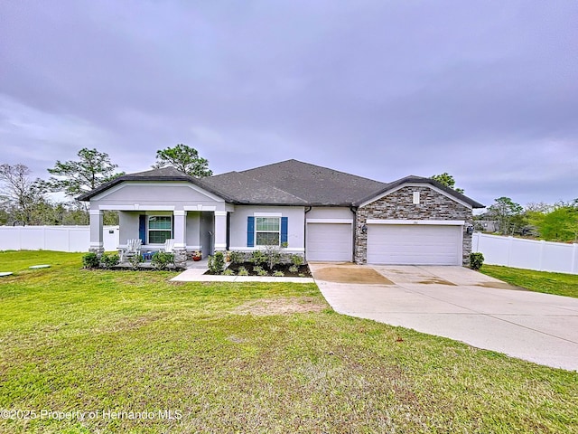 view of front facade with concrete driveway, a front yard, fence, a garage, and stone siding