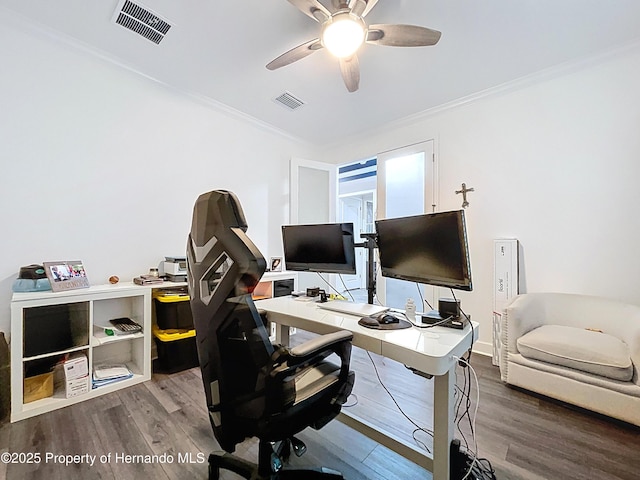 office area with a ceiling fan, visible vents, wood finished floors, and ornamental molding