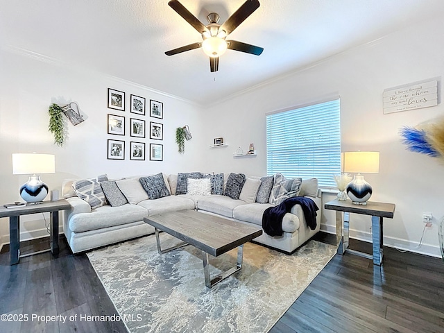 living room featuring ornamental molding, ceiling fan, baseboards, and wood finished floors