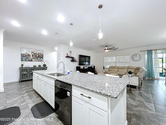 kitchen featuring a center island with sink, dishwasher, light stone countertops, white cabinetry, and a sink