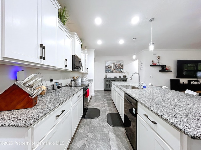 kitchen featuring light stone counters, white cabinets, a sink, and black appliances