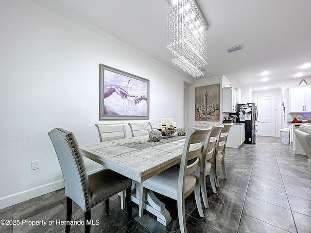 dining room with visible vents, a notable chandelier, and baseboards