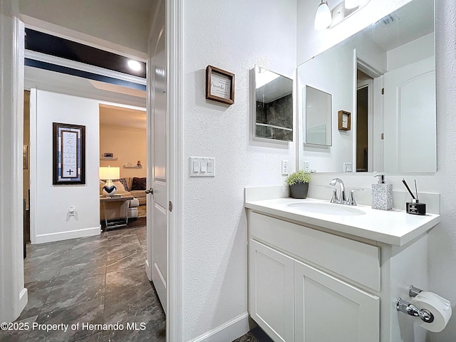 bathroom with ensuite bath, visible vents, baseboards, and vanity