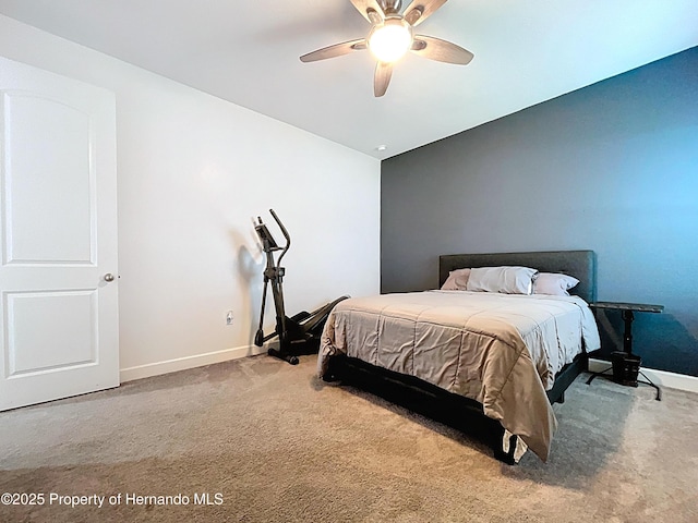 carpeted bedroom with ceiling fan and baseboards