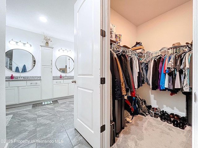 spacious closet featuring vaulted ceiling and a sink