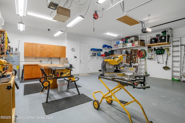 garage featuring water heater, a workshop area, and a garage door opener