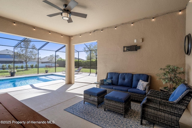 view of patio / terrace featuring a ceiling fan, a lanai, a fenced in pool, and an outdoor hangout area