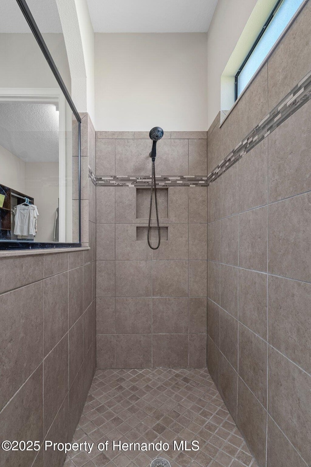 full bathroom with tiled shower