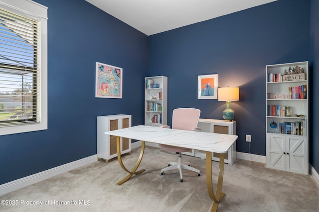 carpeted home office featuring baseboards