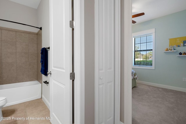 full bathroom with baseboards, tub / shower combination, toilet, and tile patterned floors