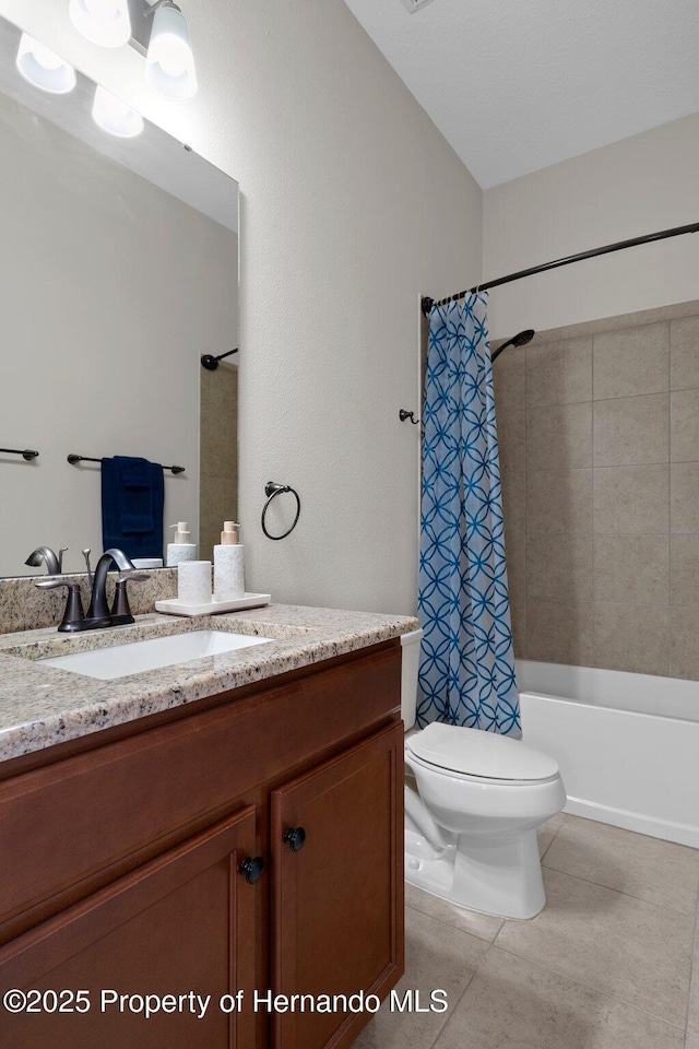 bathroom with shower / tub combo with curtain, vanity, toilet, and tile patterned floors