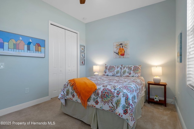 carpeted bedroom with a closet, a ceiling fan, and baseboards