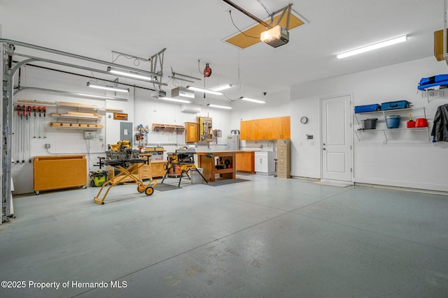 garage featuring a workshop area and a garage door opener