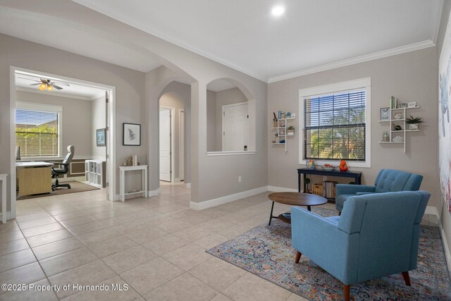 living room featuring ornamental molding, arched walkways, light tile patterned flooring, and baseboards