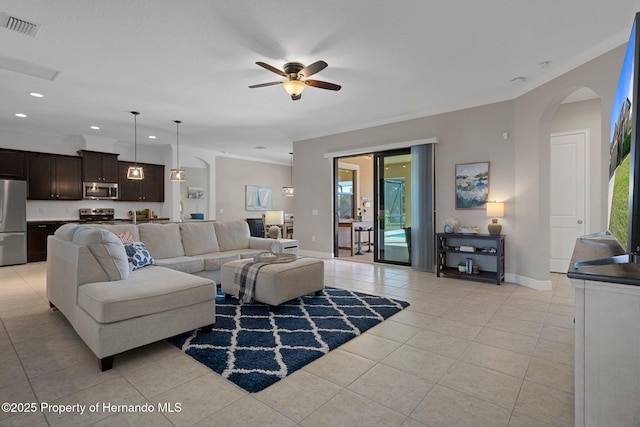 living area with light tile patterned floors, ornamental molding, visible vents, and recessed lighting