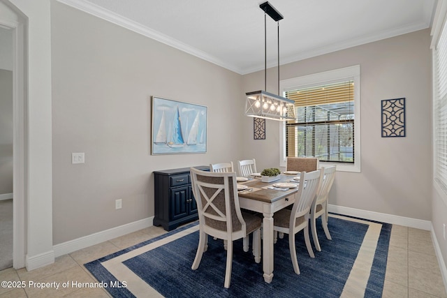 dining area with light tile patterned flooring, crown molding, and baseboards