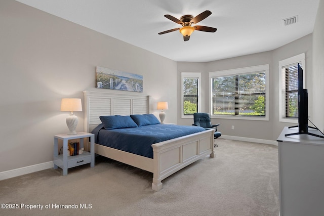 bedroom featuring baseboards, visible vents, and light colored carpet