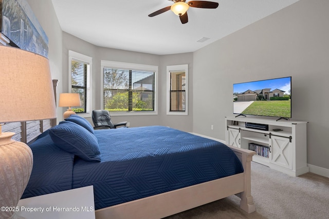 carpeted bedroom with visible vents, baseboards, and ceiling fan