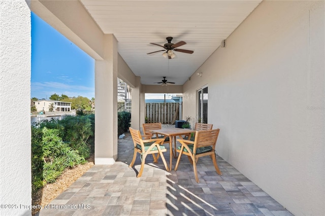 view of patio / terrace featuring outdoor dining area, fence, and a ceiling fan