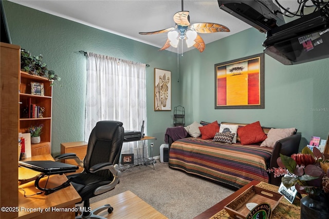 carpeted bedroom featuring a textured wall and ceiling fan