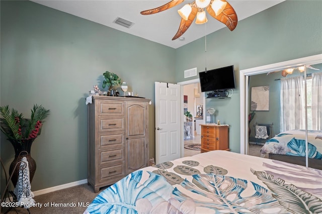 carpeted bedroom featuring ceiling fan, visible vents, and baseboards