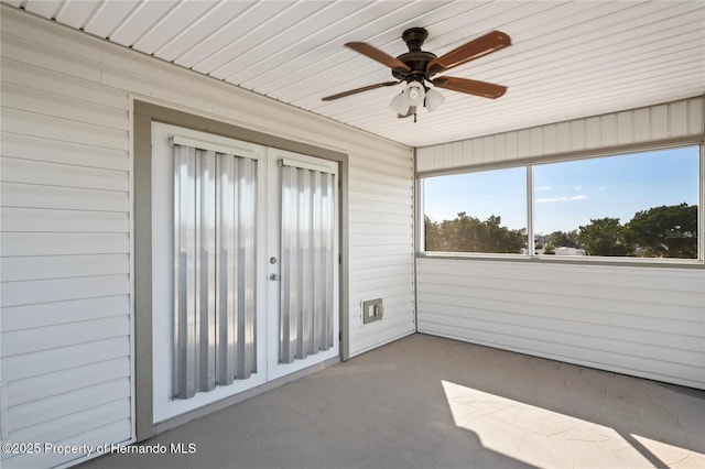 unfurnished sunroom with a ceiling fan