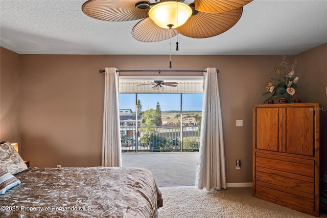 carpeted bedroom featuring baseboards, access to outside, a ceiling fan, and a textured ceiling