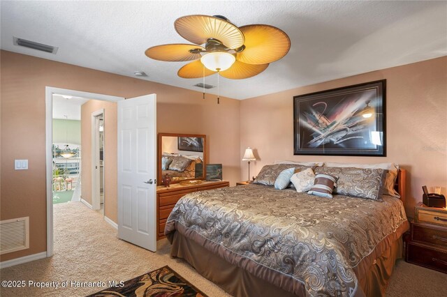 carpeted bedroom with ceiling fan, visible vents, and baseboards