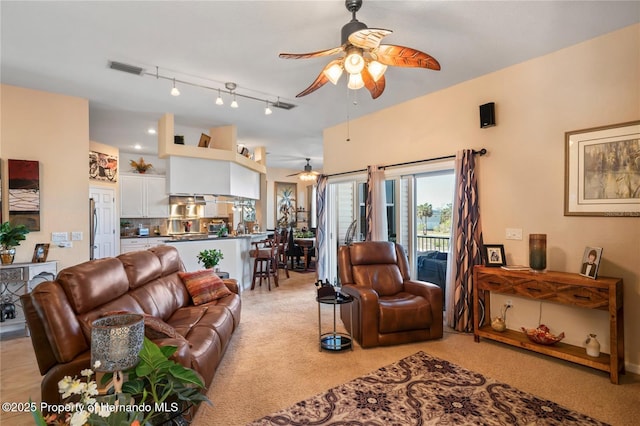 living area with ceiling fan, rail lighting, and visible vents