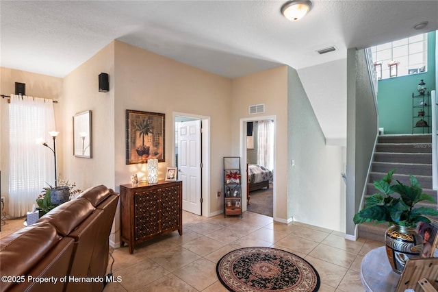 interior space featuring stairway, visible vents, and a wealth of natural light