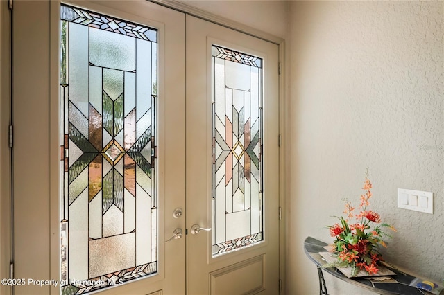 doorway featuring a textured wall and french doors