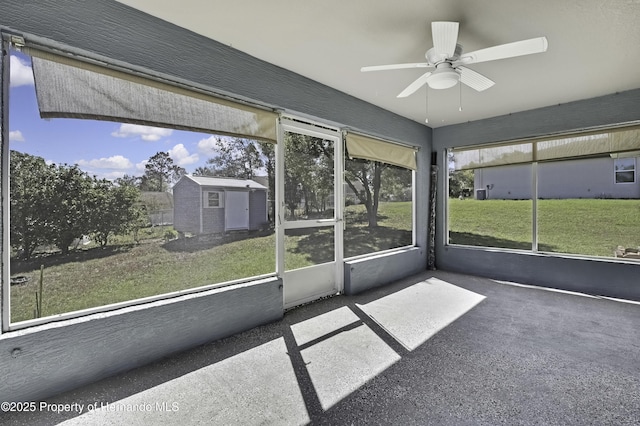 unfurnished sunroom with ceiling fan