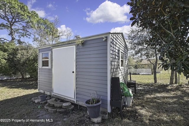 view of shed featuring fence