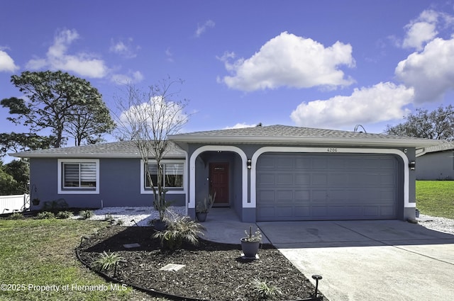 ranch-style home with a garage, driveway, and stucco siding