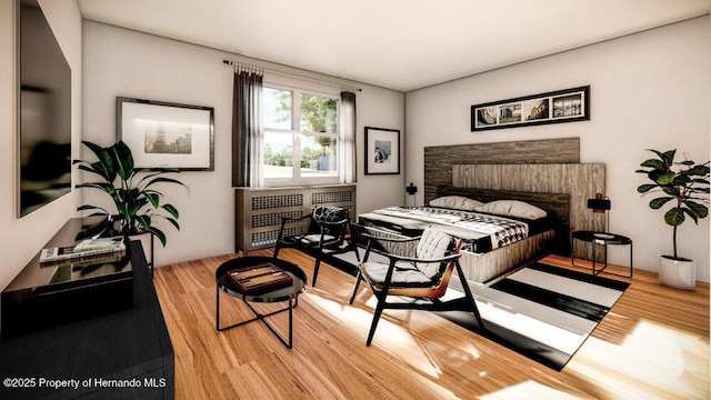 bedroom featuring radiator and wood finished floors