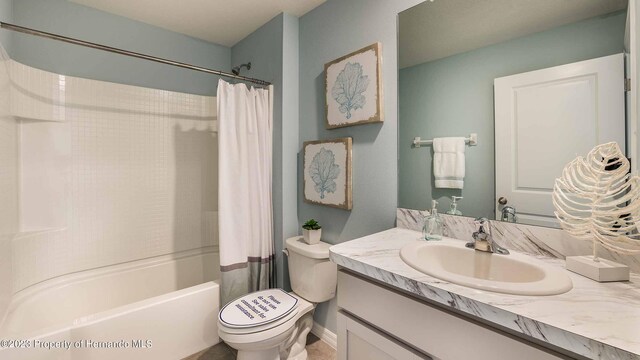 bathroom with shower / tub combo, vanity, and toilet