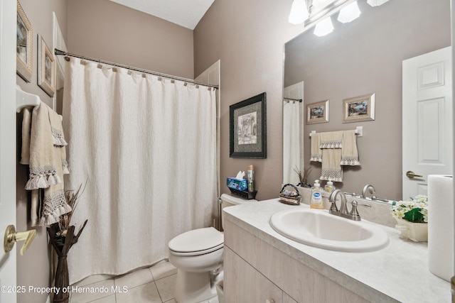 bathroom with vanity, toilet, and tile patterned floors