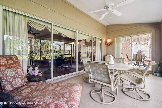 sunroom / solarium with lofted ceiling and a ceiling fan