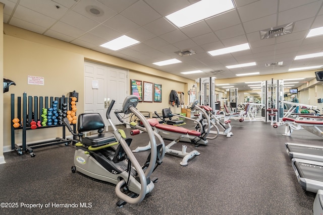 gym featuring a paneled ceiling and visible vents