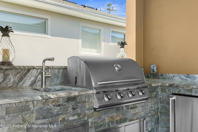 view of patio / terrace with a sink, an outdoor kitchen, and area for grilling