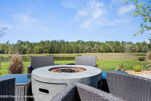 view of patio featuring an outdoor fire pit and a water view