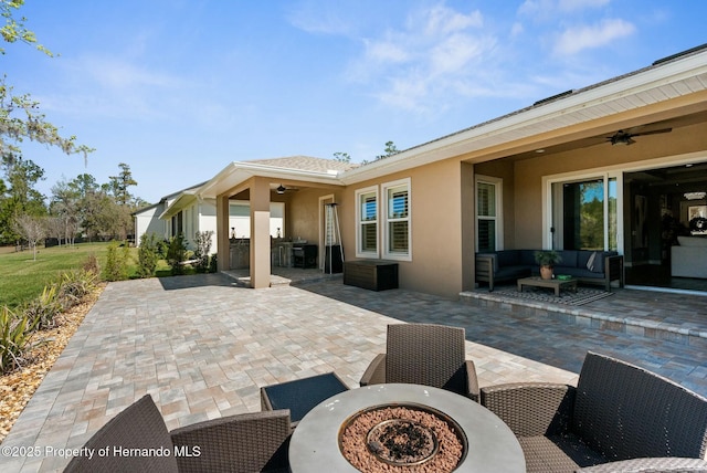 view of patio with outdoor lounge area, a ceiling fan, and outdoor dining space