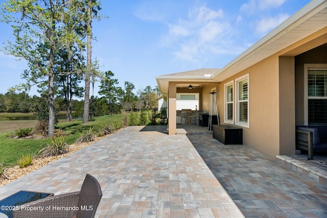 view of patio featuring a ceiling fan and exterior kitchen