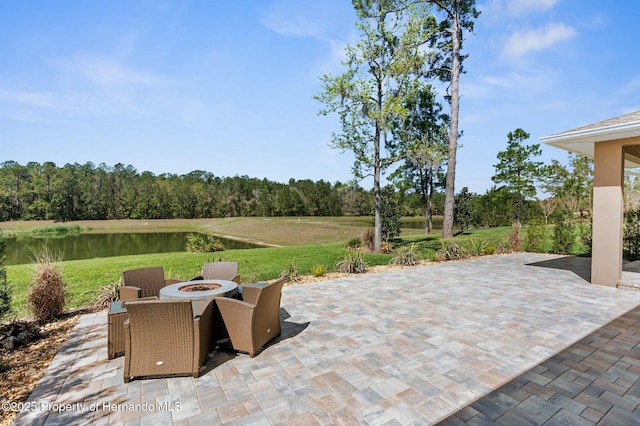 view of patio / terrace featuring a water view and a fire pit