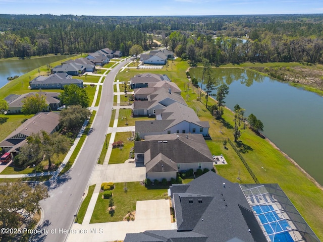 aerial view with a water view, a residential view, and a view of trees