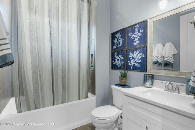 bathroom featuring shower / tub combo with curtain, vanity, and toilet